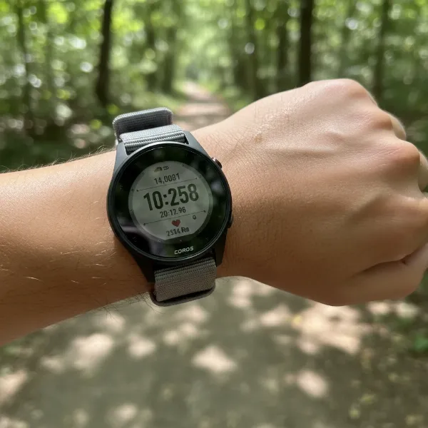Close-up of Coros Pace 4 on a runner's wrist, emphasizing its lightweight and slim profile.