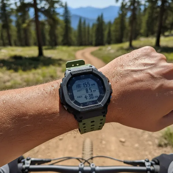 Person wearing a Casio G-Shock Move smartwatch during a running workout, displaying fitness data.
