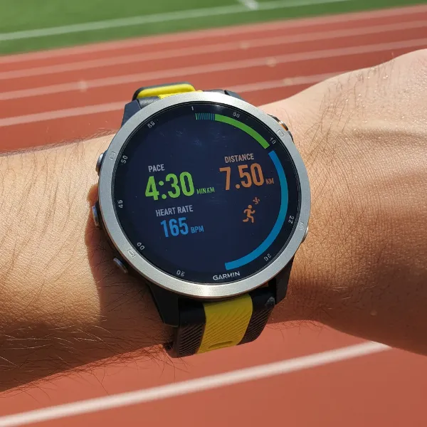Garmin Forerunner 965 with vibrant AMOLED display showing running metrics