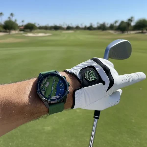 Tag Heuer Connected Golf Edition watch on a golfer's wrist on a golf course, displaying course map.